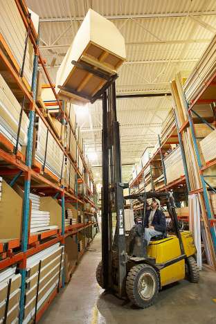 man doing his job driving a forklift in a warehouse