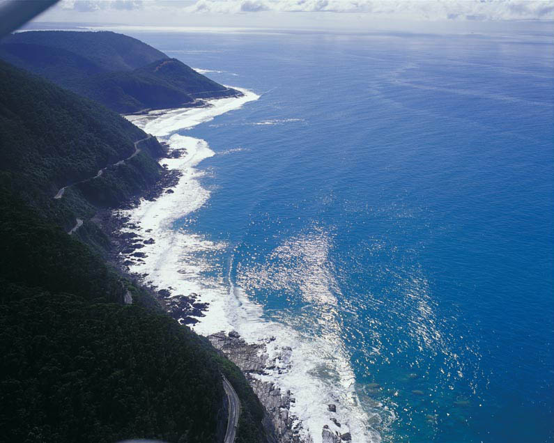 an aerial view of the great ocean road winding along the coast
