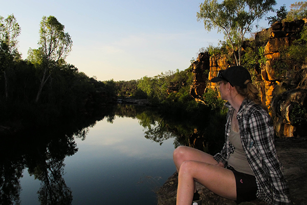 Girl sitting by lake Western Australia Girl on lake