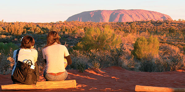 Sitting by Uluru best things to do around Australia