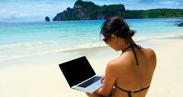 girl-on-beach-with-laptop claim your UK tax refund