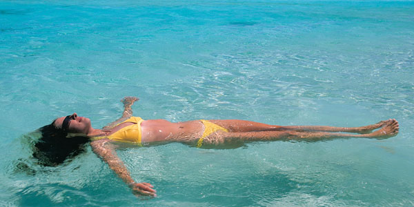 girl lying on the water in western australia