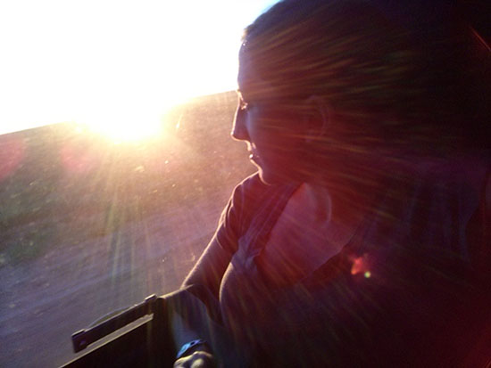woman looking out a coach window