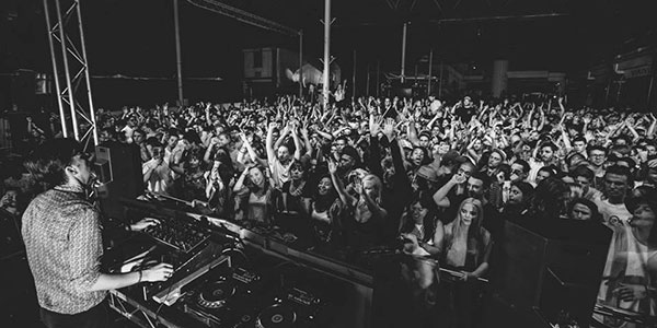 smalltown-warehouse DJ and crowd at warehouse party