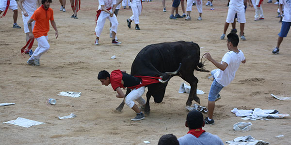 stoke-travel-running-of-the-bulls man caught in bull horn during running of the bulls