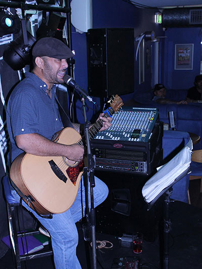 man playing with guitar on stage