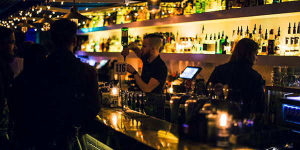 barman serving drinks in Sydney bar