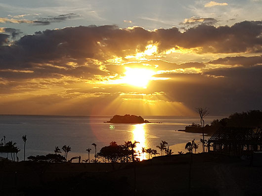 sunset over island in fiji