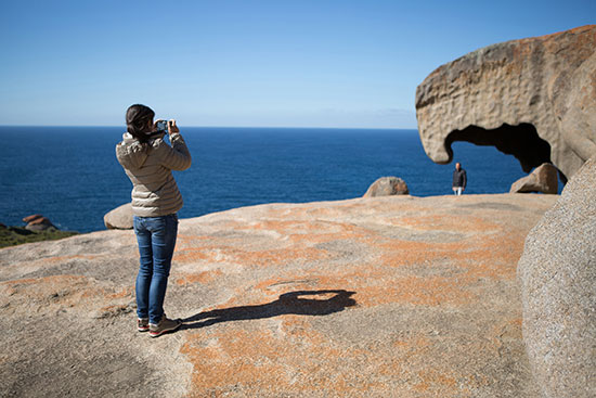girl taking photo of remarkable rocks on kangaroo island