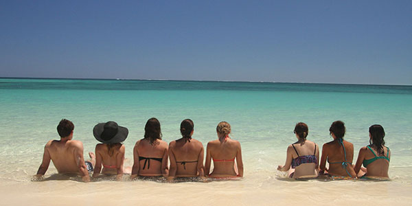 aussie-wanderer-sitting-on-the-beach girls sitting in the water on a beach in australia