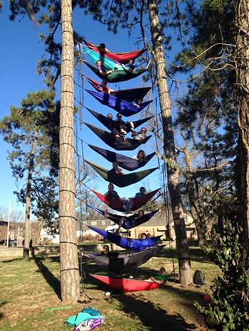 people in hammocks one on top of another