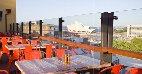view of the sydney opera house from a rooftop bar