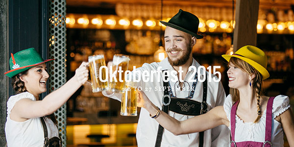 three people drinking during oktoberfest