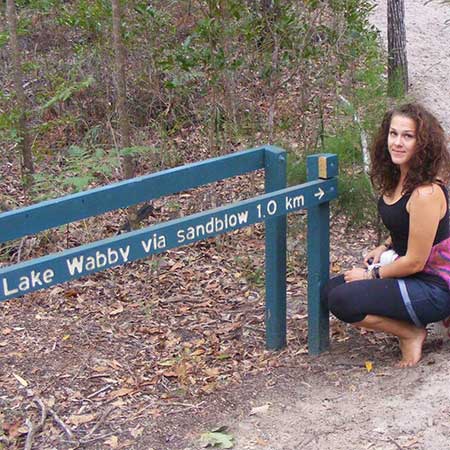 girl standing by sign for lake wabby fraser island