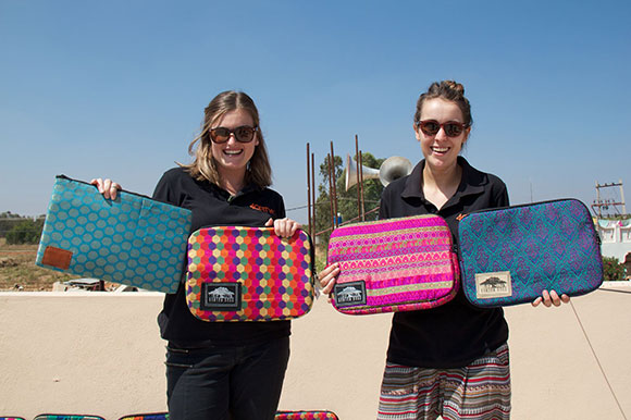 girls holding laptop bags