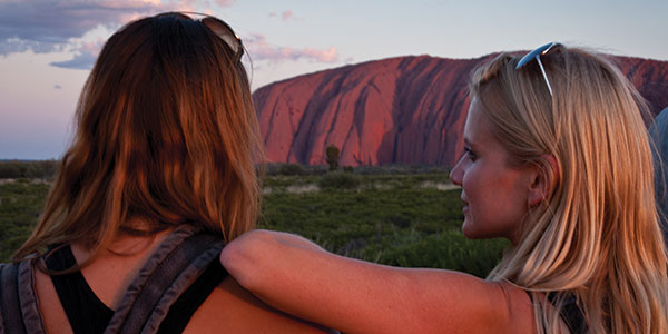girls looking at uluru australia