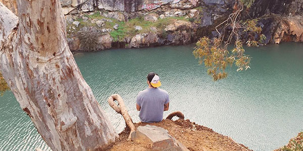 benjamin-hodgetts-instagram man sitting by river in western australia