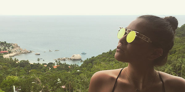 girl standing standing in front of ocean in thailand