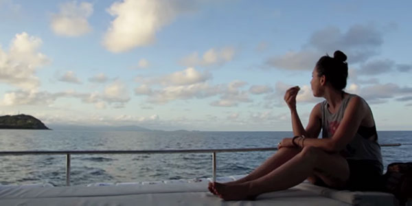 united-port-douglas-promo-video girl sitting on boat in australia