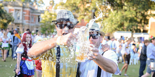 oktoberfest-in-the-gardens-beer two men clinking pints of beer