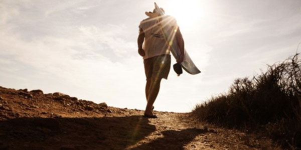 surfer walking to the beach