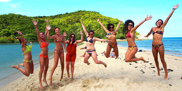 girls jumping on beach