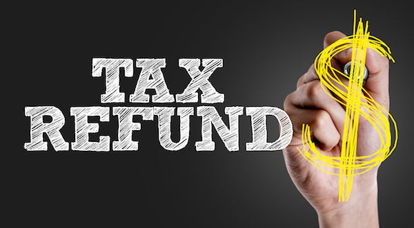 Hand writing the text: Tax Refund tax refund with dollar sign