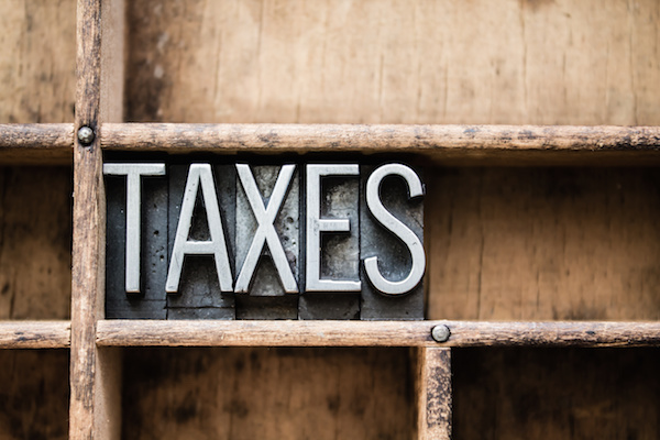 Taxes Vintage Letterpress Type in Drawer the word taxes on wood shelf