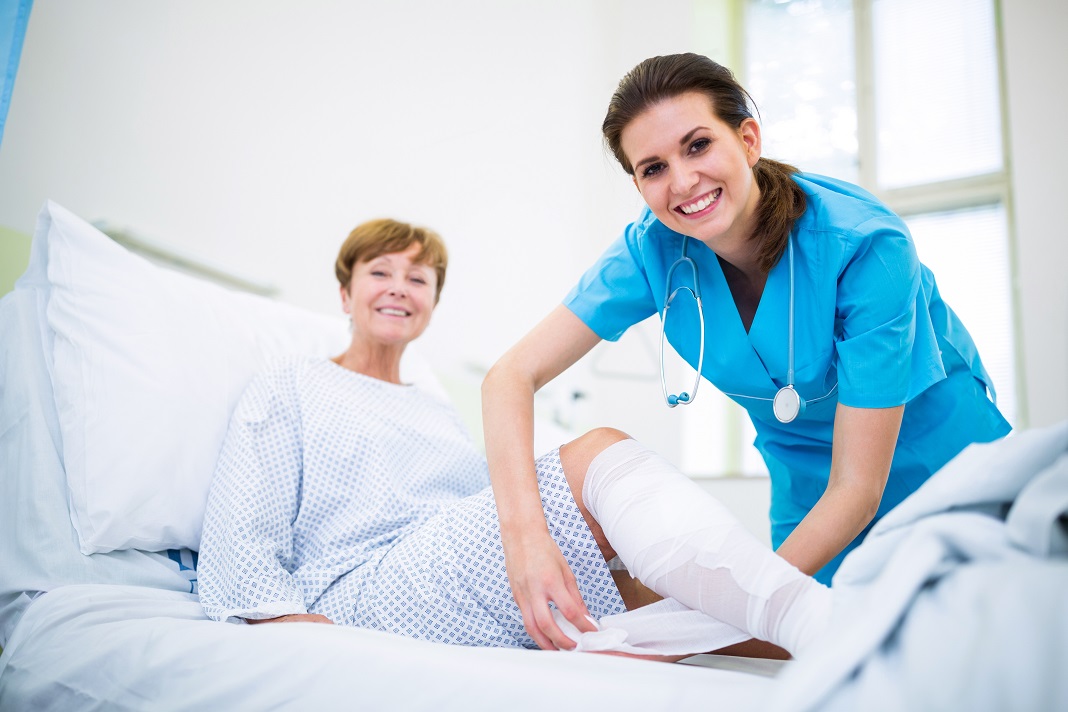 Nurse bandaging leg of patient Nursing Jobs in Queensland for Working Holiday Visa Holders