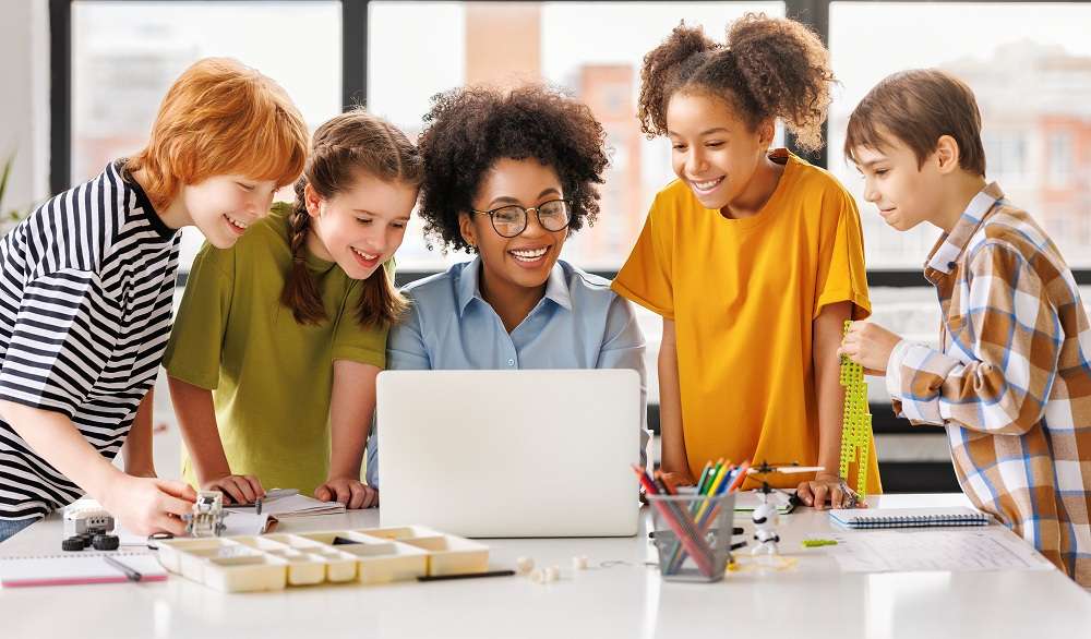 Parenting In The Digital Age Teacher and students watching laptop screen