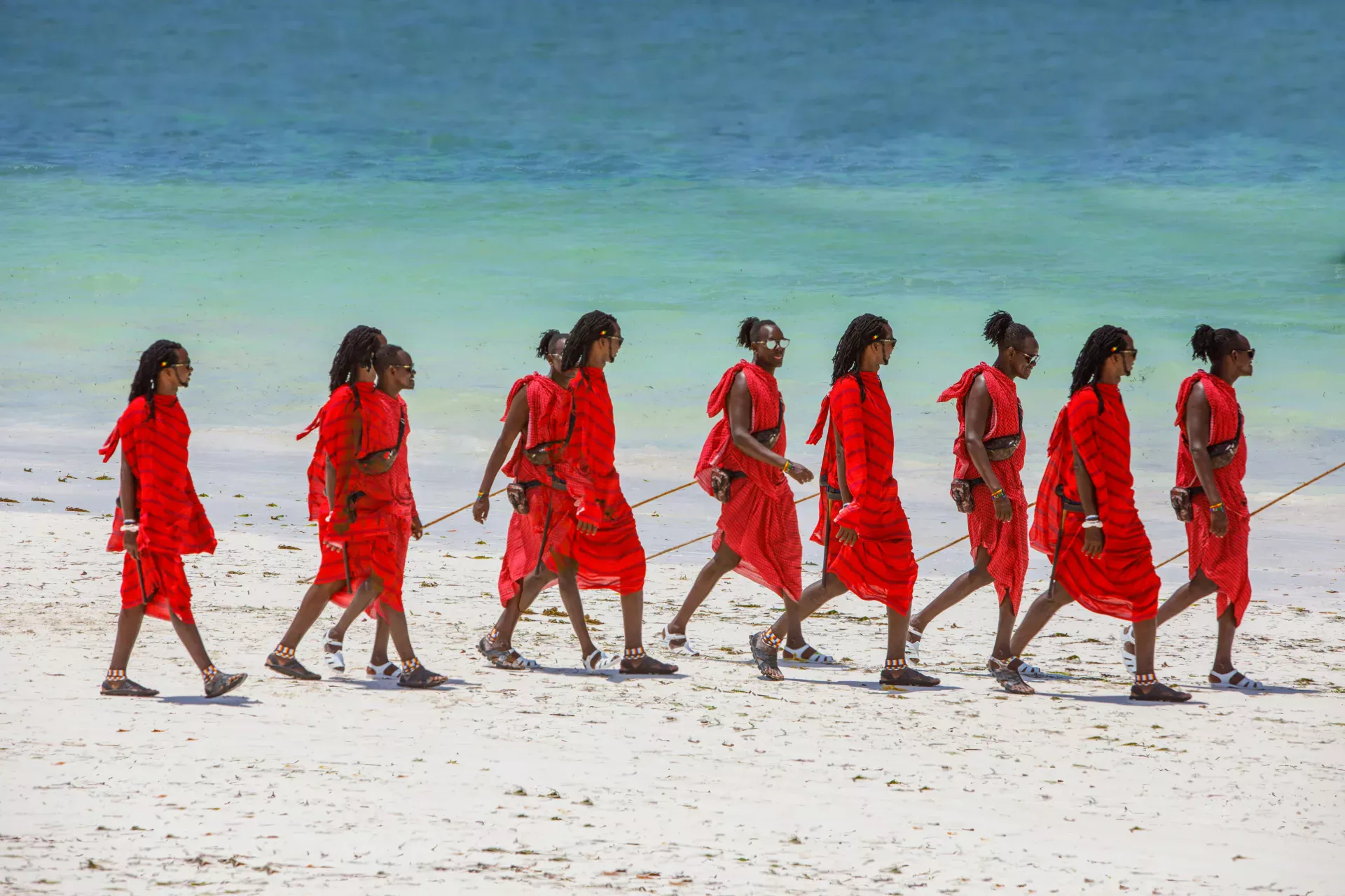 Group of Maasai Warriors Walking on Tropical Beach maasai warriors